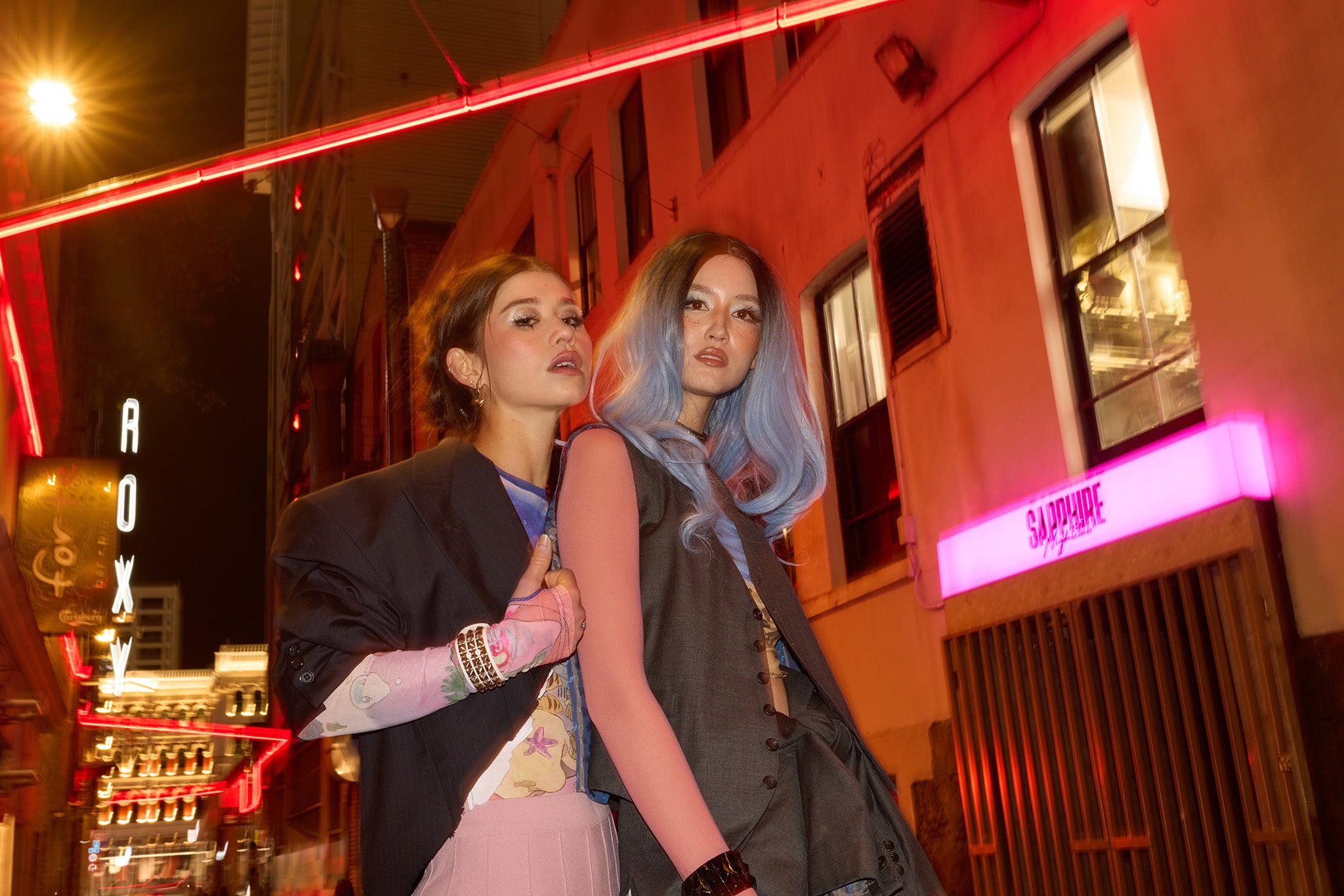 Two fashion subjects photographed at night with direct flash