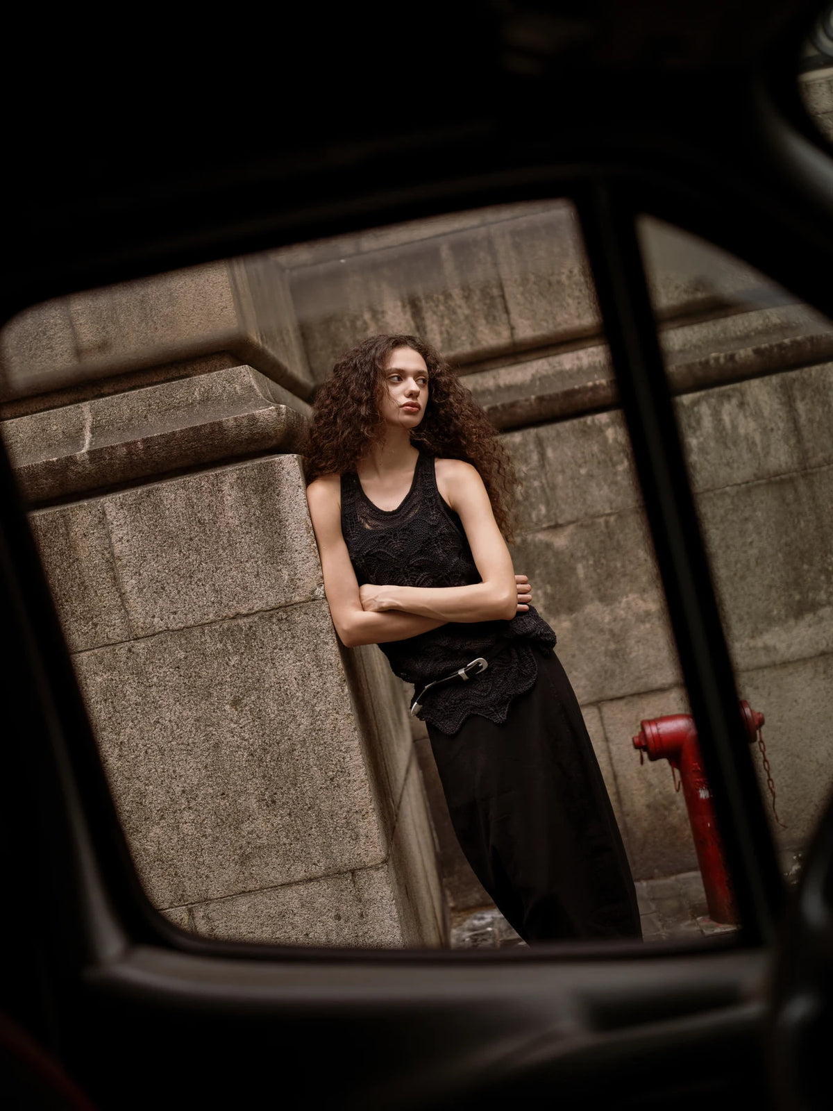 Environmental portrait framed through a reflection, photographed with the AF 35mm F1.4 Pro FE